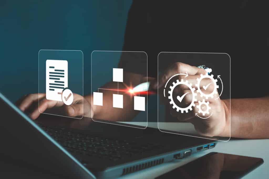 Standard operating procedure (SOP) concept. Businessmen use laptop computers with virtual SOP icons for the SOP, which includes instruction, quality, process, operation, sequence, and workflow. AdobeStock 1089899367 scaled 1