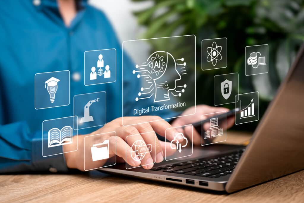Digital transformation and AI technology strategy concept, Businessman use laptops and Artificial Intelligence to enhance business capabilities, Automation industry, Cloud computing data, Education AdobeStock 1153905122 scaled 1